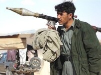 An Afghan policeman guards a checkpoint in Musa Qala after Taliban fighters fled the town (AFP)