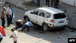 Tunisian police inspect a vehicle that was booby-trapped on July 27 on the outskirts of the Tunisian capital, Tunis.