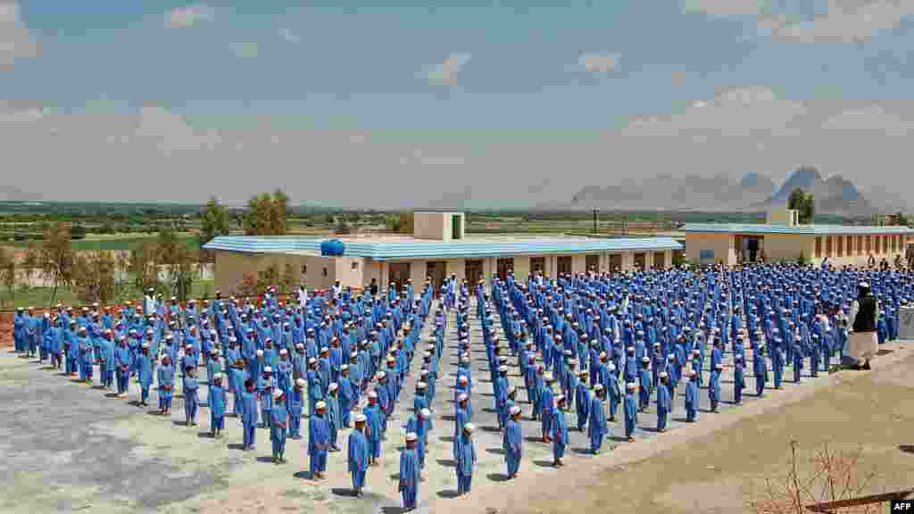 Children line up at an orphanage in Kandahar, Afghanistan. Two decades of war has left some 1 million orphans and abandoned children across the country. (AFP/Mamoon Durrani)