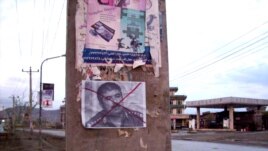 A defaced poster of ethnic Uzbek leader Abdul Rashid Dostum, the chairman of the Joint Chiefs of Staff of the Afghan National Army
