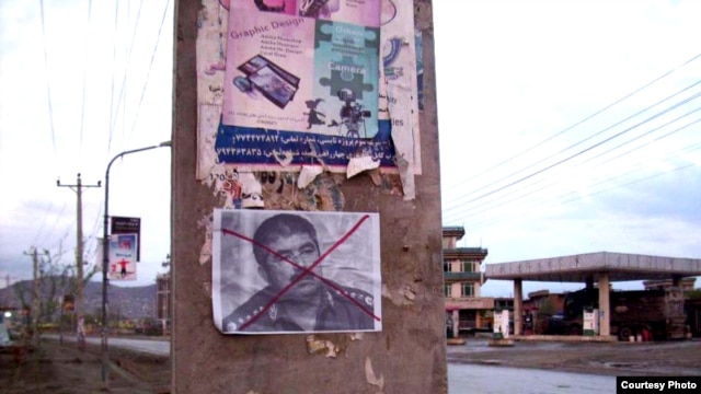 A defaced poster of ethnic Uzbek leader Abdul Rashid Dostum, the chairman of the Joint Chiefs of Staff of the Afghan National Army