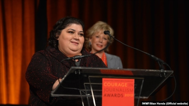 RFE/RL Azerbaijani service correspondent Khadija Ismayilova accepting the 2012 "Courage in Journalism" award from the International Women's Media Foundation. Behind Ismayilova is Lesley Stahl, CBS News journalist and presenter of the award. The ceremony took place in New York on October 24, 2012. Photo: IWMF/Stan Honda