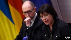 Ukrainian Prime Minister Arseniy Yatsenyuk (left) and Finance Minister Natalie Jaresko are in Washington this week to meet with the International Monetary Fund (IMF), promote Ukraine as an investment destination, and ask U.S. officials for more economic and military support.