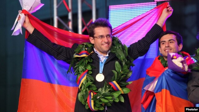 Armenia - Grandmasters Levon Aronian (L) and Gabriel Sargsian celebrate their team's victory in the 2012 World Chess Olympiad in Yerevan's Liberty Square, 10Sep2012.