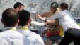 Security! Guards try to prevent topless Femen activist Yulia Kovpachyk from grabbing the Euro 2012 trophy in Kyiv on May 12.