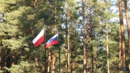 Russian and Polish state flags in fly at the site of the Katyn massacre in Smolensk, Russia.