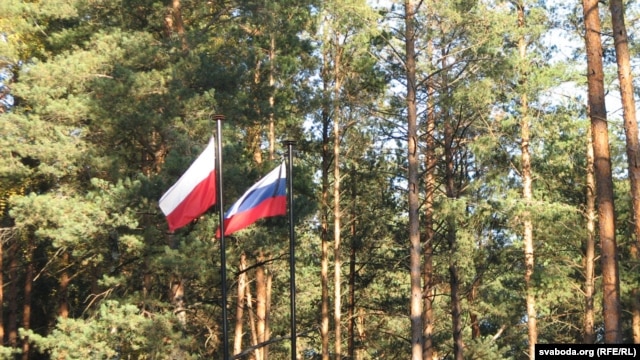 Russian and Polish state flags in fly at the site of the Katyn massacre in Smolensk, Russia.