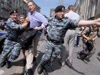 A British activist is detained by police during the May 17 gay-rights demonstration in Moscow (ITAR-TASS)