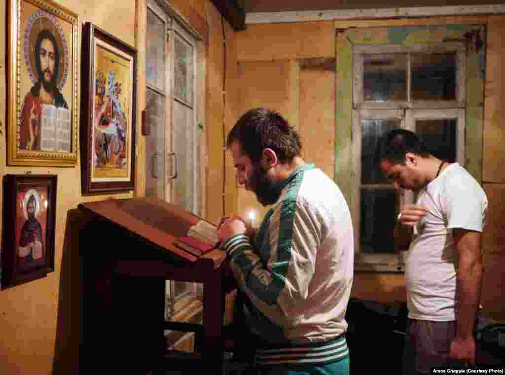 Sergo Mikhelidze (left) and Irakli Kurashvili pray in their dormitory at the base of the pillar. Sergo worked in a factory until being laid off and is considering life as a priest or monk. He will stay at the monastery for three months to see if he is strong enough to commit to the life of a holy man. When asked what he has trouble avoiding in the outside world, he says: "I just can't seem to stay away from girls."