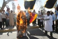 Iraqis burn an effigy of the pope during a demonstration in Al-Basrah on September 18 (epa)