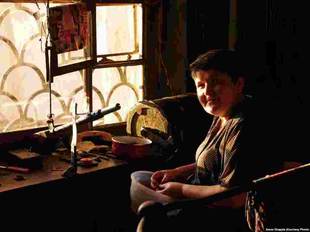 An operator pits cherries in the downtime between passengers. Operators usually wait until there are three or four passengers waiting at both stations before ringing the bell and starting the ride.
