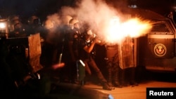 Riot police fire tear gas at protesters during clashes in Hatay.