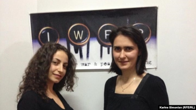 RFE/RL Armenian Service reporters Ruzanna Stepanyan (left) and Lilit Harutyunyan following the award ceremony, held at IWPR's Tbilisi office on December 3, 2012.