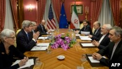 U.S. Undersecretary for Political Affairs Wendy Sherman (left to right), U.S. Secretary of State John Kerry, U.S. Secretary of Energy Ernest Moniz, U.S. National Security Council member Robert Malley, Iranian Deputy Foreign Minister Abbas Araqchi, Iran Atomic Energy Organization head Ali Akbar Salehi, Iranian Foreign Minister Mohammad Javad Zarif, and Hossein Fereydoon, special assistant to the Iranian president, wait to start a meeting in Lausanne, Switzerland, on March 29.