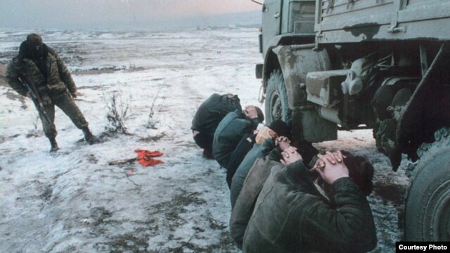 Detainees under Russian guard in Chechnya in a photo by Adam Borowski that is part of a photo exhibition in Prague called "Chechnya: The Final Solution"