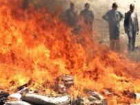 Afghan officials destroy a haul of illegal opiates (AFP)
