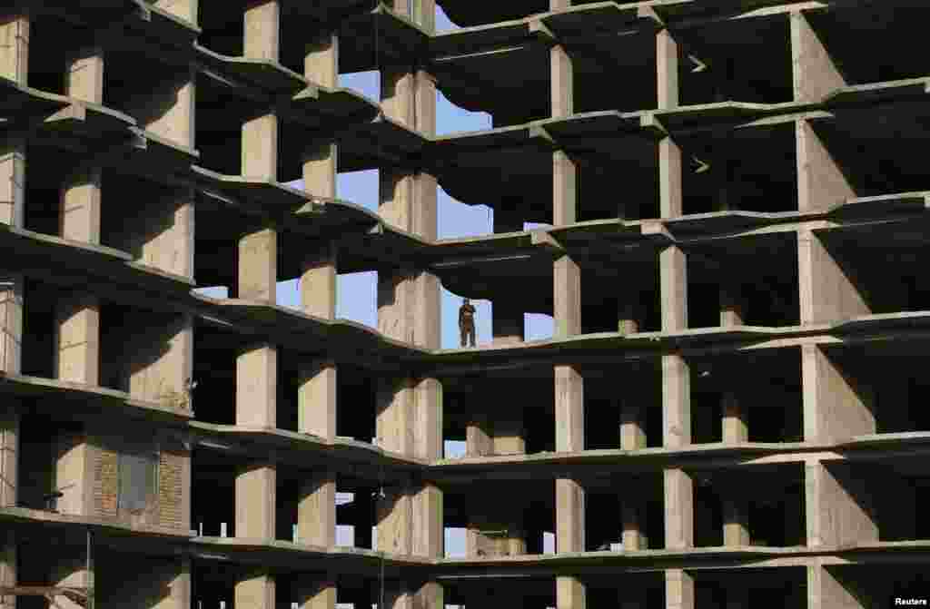 An Afghan worker stands at the site of a residential complex under construction in Kabul. (Reuters/Omar Sobhani)