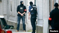 Police at the scene where shots were fired during a counterterrorism operation in Brussels on March 15.