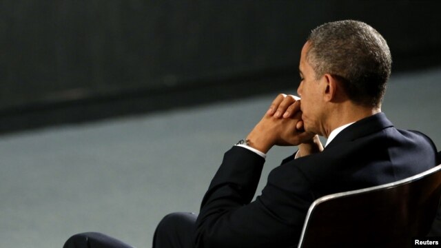 U.S. President Barack Obama prays during a vigil held at Newtown High School for families of victims of the Sandy Hook Elementary School shooting.