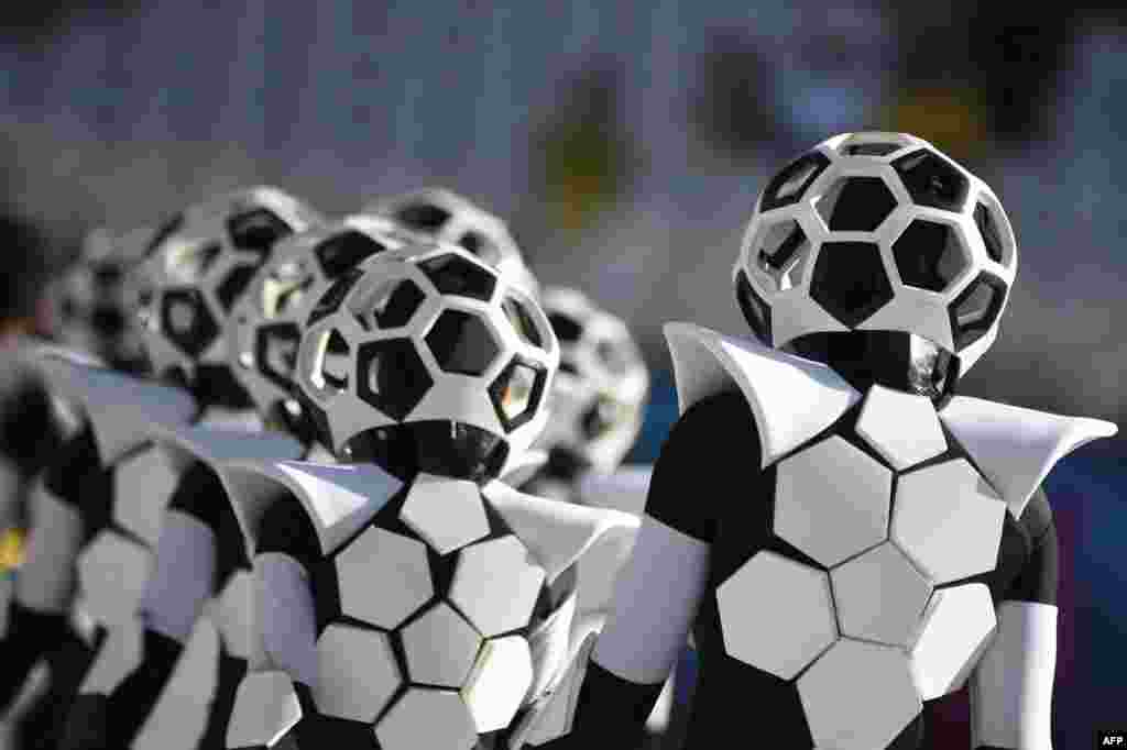 Performers dressed as soccer balls take part in the World Cup's opening ceremony.
