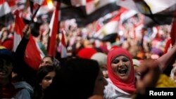 Protesters opposed to President Muhammad Morsi hold a poster of Egyptian armed forces commander General Abdel Fattah al-Sisi in Tahrir Square in Cairo on July 3.