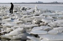A man walks on an ice-covered tributary of the Amur (epa)