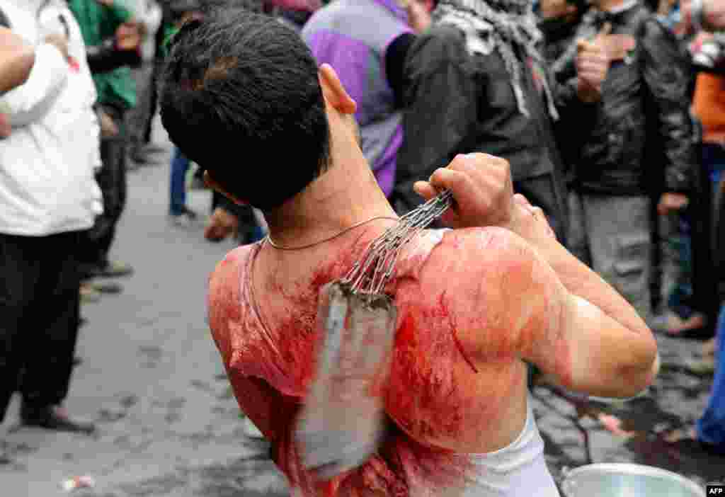 A Kashmiri Shi'ite Muslim performs an act of self-flagellation during an Ashura religious procession in Srinagar, India. (AFP/Rouf Bhat)