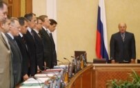 Prime Minister Fradkov (right) leading a moment of silent during a cabinet meeting in Moscow today (TASS)