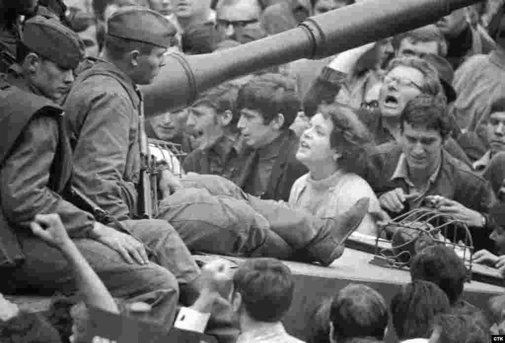 A Czechoslovak woman talks to Soviet soldiers on a tank as she protests against the invasion in Prague.