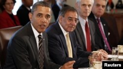 U.S. President Barack Obama (left) is flanked by Defense Secretary Leon Panetta as he speaks at a Cabinet meeting in Washington in late January.