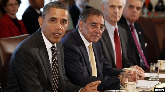 U.S. President Barack Obama (left) is flanked by Defense Secretary Leon Panetta as he speaks at a Cabinet meeting in Washington in late January.