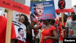 Demonstrators carry signs as they attend a protest in Lagos on May 9 demanding the release of the more than 250 school girls abducted by militants in the remote village of Chibok.
