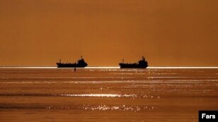 Two ships sail by the Iranian Persian Gulf port of Bandar Imam Khomeini in Khuzestan Province. (Fars News Agency)