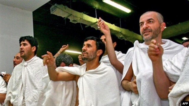Iranian President Mahmud Ahmadinejad (center) throws stones at a column symbolizing the devil in Mecca.