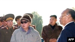 North Korean dictator Kim Jong Il (in sunglasses) visiting the cemetery of fallen fighters of the Chinese People's Volunteers with son Kim Jong Un (second from right),who's been tabbed as a possible successor, in October.