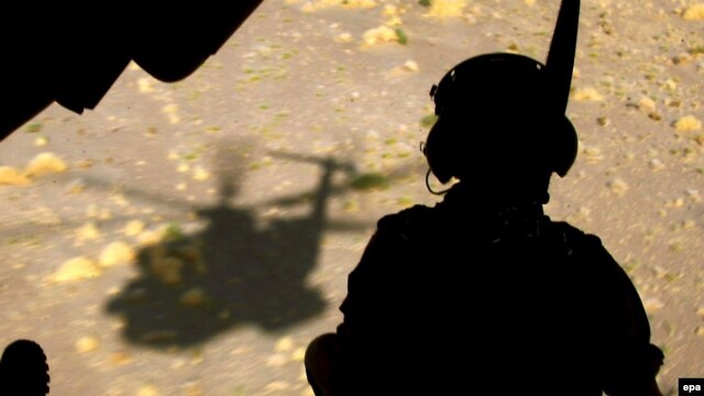 A German soldier sits in the back of a helicopter in Konduz (file photo)