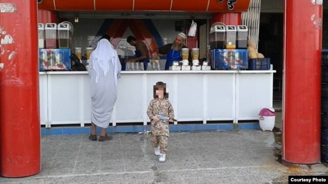 Abdrakhman in fatigues outside a Mosul juice bar
