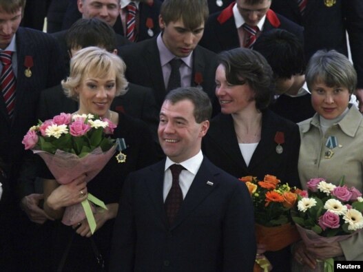 Russian President Dmitry Medvedev (center) poses with Russian Olympians after an awards ceremony in the Kremlin on March 15.
