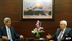 U.S. Secretary of State John Kerry (left) meets with Palestinian Authority President Mahmud Abbas on July 19 in the West Bank city of Ramallah.