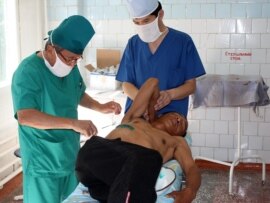Doctors treat a victim of the ethnic violence in Osh in June 2010.