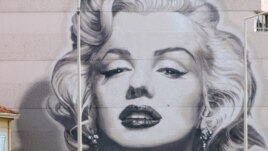 France -- People drive past a giant picture of Marylin Monroe,  two days ahead of the Cannes film festival in Cannes, 15May2006