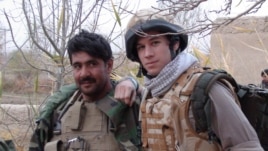 Patrick Hennessey (right) poses with Qiam, an Afghan National Army officer, in Helmand in 2009.
