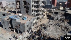 People walk among the ruins of damaged buildings following heavy fighting between government troops and Kurdish fighters in the Turkish town of Cizre near the Iraq-Syria border earlier this year. Although many blame the Sykes-Picot Agreement for much of the volatility that plagues the Middle East, there are others who suggest that alternative scenarios might have turned out much worse.