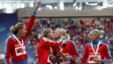 Russia's gold medal-winning team kiss and celebrate their women's 4x400-meter relay victory at the IAAF World Athletics Championships in Moscow on August 17.