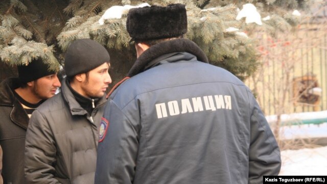 Two of the Uzbek asylum seekers wait outside the Almaty administrative court during their trial in January 2011.