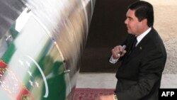 Turkmenistan President Gurbanguly Berdymukhammedov, seen here signing the East-West gas trunk pipeline in Shatlyk in May 2010, was reelected to a second term earlier this month.