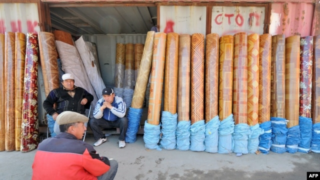 Traders sit outside a converted shipping container at a bazaar in southern Kyrgyzstan.