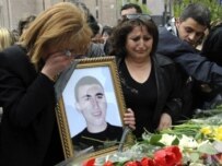 Relatives of a protester killed during clashes surrounding the presidential election lay flowers in his memory in Yerevan (AFP)