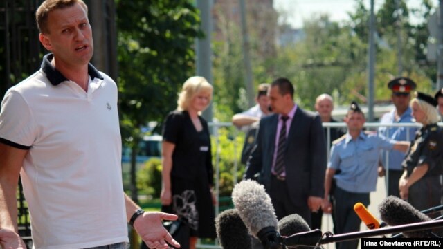 Russian opposition blogger Aleksei Navalny talks to reporters before meeting with police investigators on July 31. 