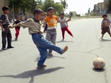 Iraq - Iraqi children play football at an empty street in Baghdad, 09Apr2007